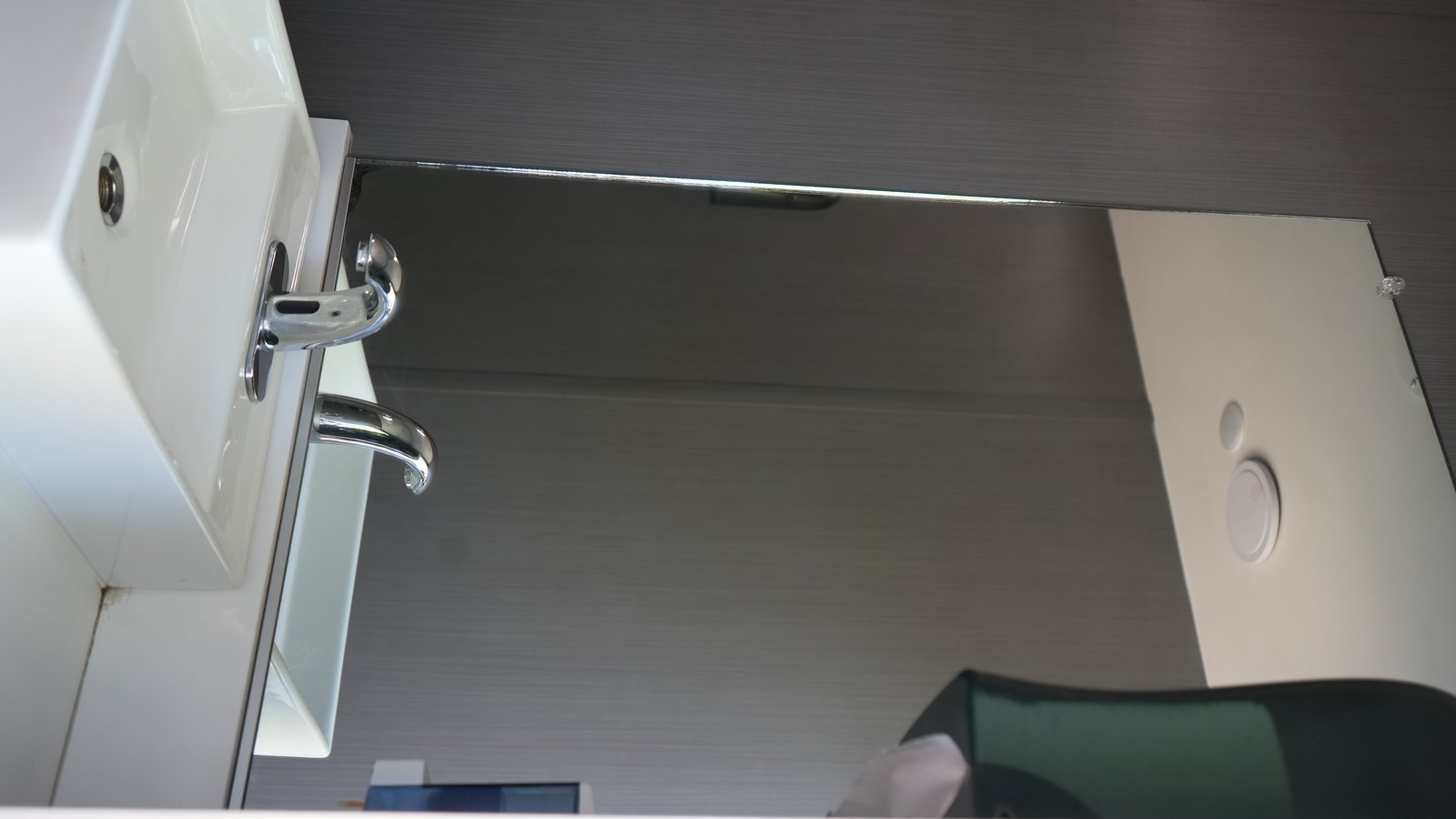 Stainless steel sink with chrome faucet and full-length mirror