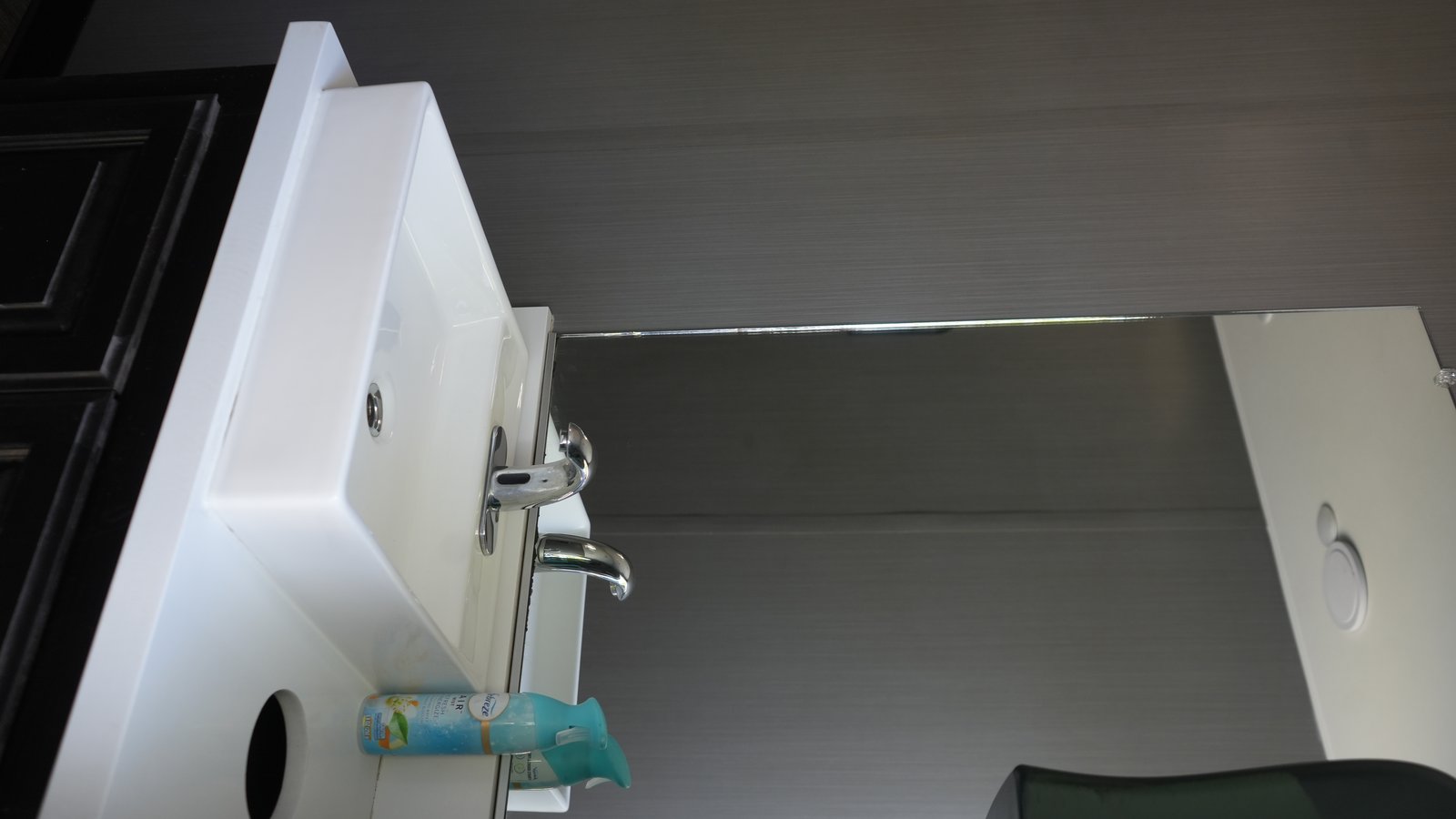 Premium sink area with soap dispensers and dark cabinetry
